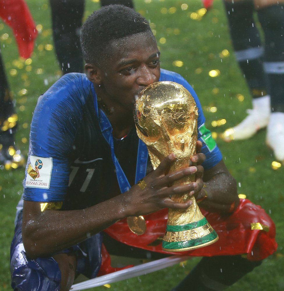 Ousmane Dembélé holding the 2018 FIFA World Cup trophy