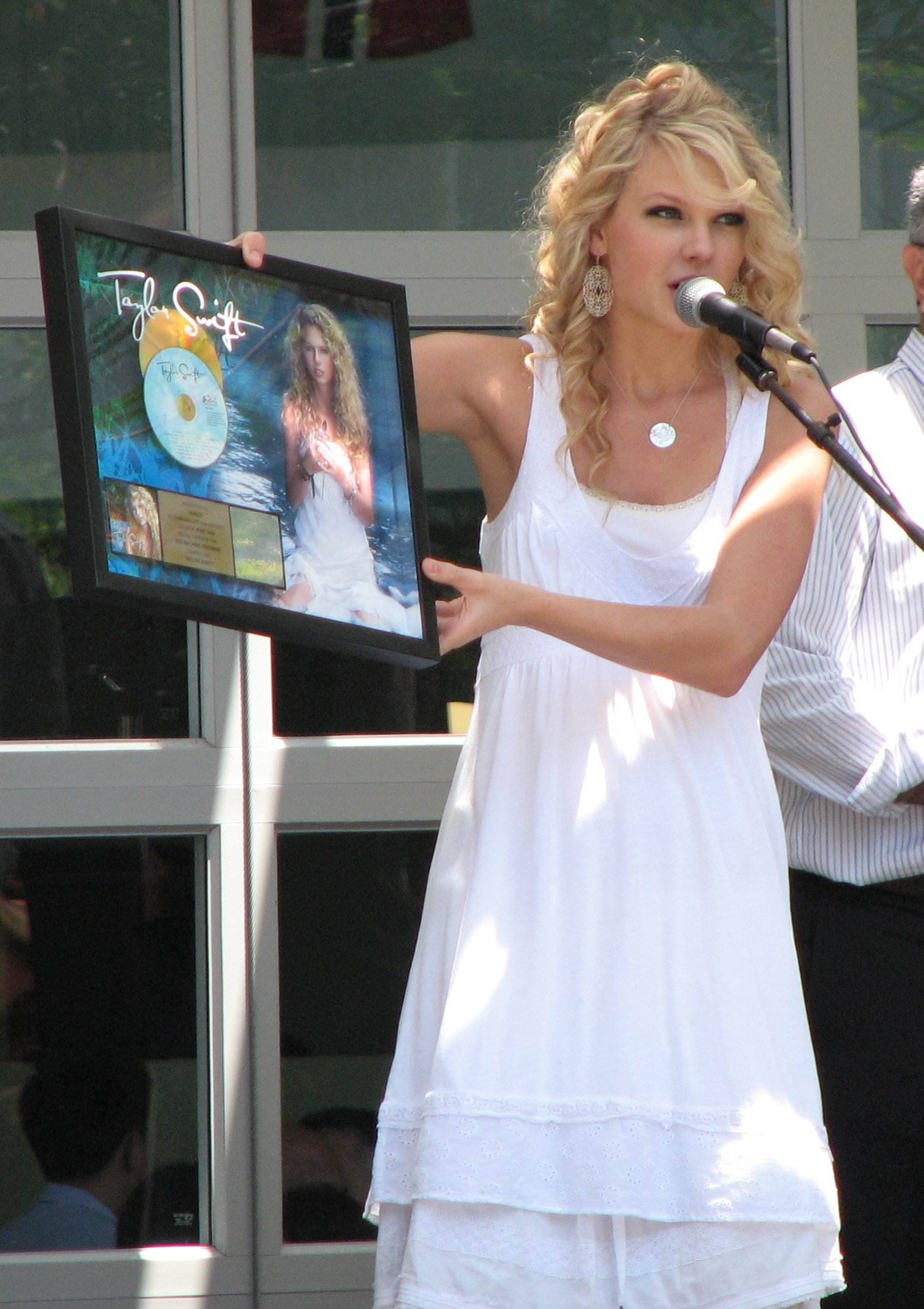 Taylor Swift at age 17 in 2007 holding a gold record