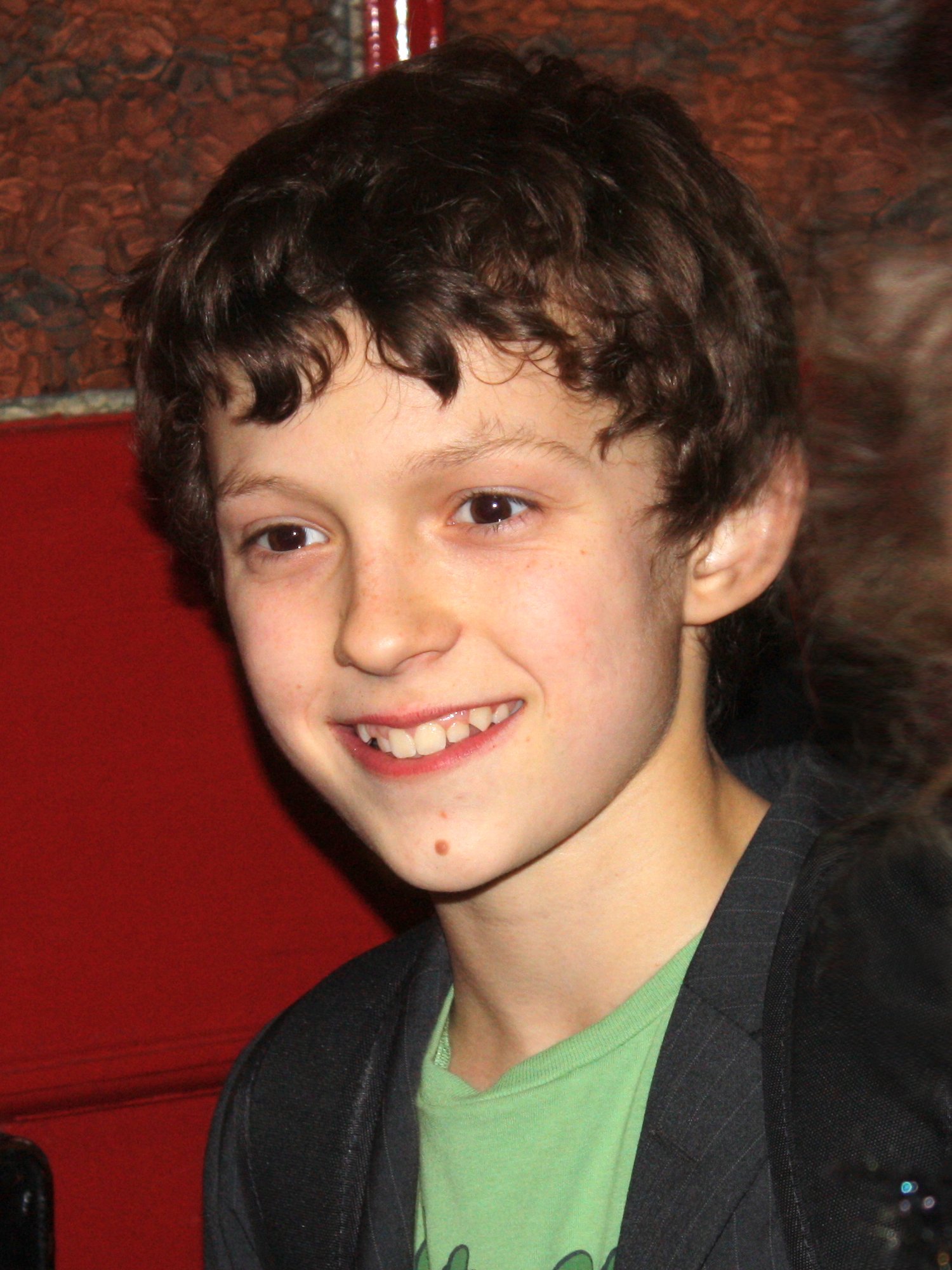 A young Tom Holland in 2010 smiling during his Billy Elliot stage days
